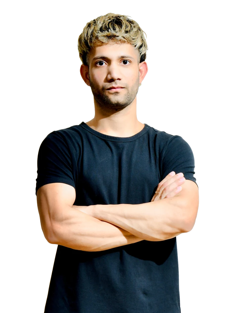 Bhanu Vashisht, online biomechanics and movement coach, arms folded and looking at the camera